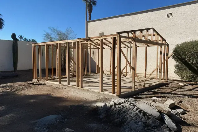 Skeletal wooden framework of a detached garage demolition in Tempe, AZ.