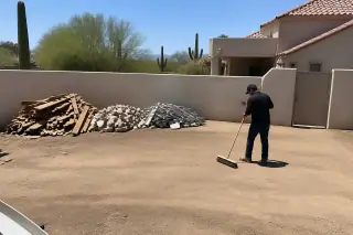 Sorted pile of wood, metal, and masonry waste on a cleaned demolition site in Phoenix, AZ.