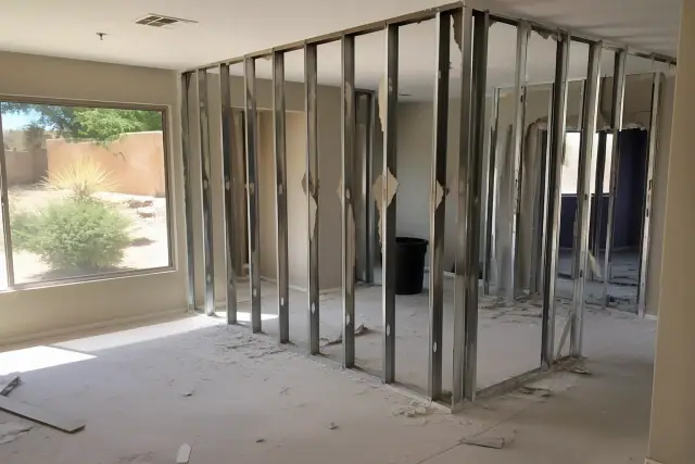 Partially dismantled drywall and metal wall studs during a residential gut renovation in Gilbert, AZ.