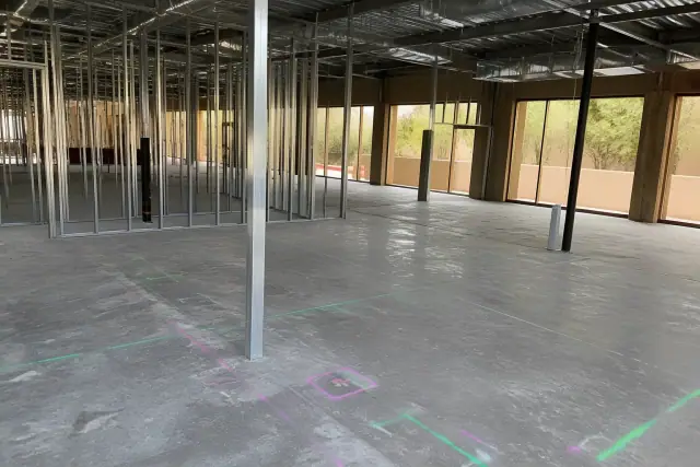Site assessment markers on a concrete floor during a pre-demolition survey in a Phoenix, AZ building interior.