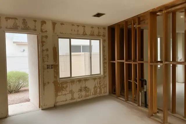 Interior of a residential home under demolition with exposed wall framing in Surprise, AZ.