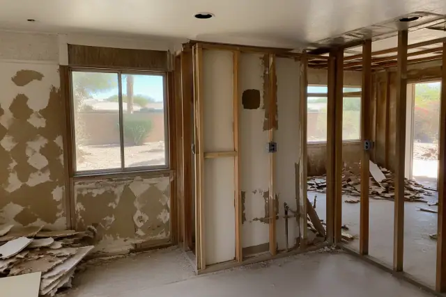 Room-by-room residential deconstruction in progress at a job site in Phoenix, AZ with exposed wall studs and debris.
