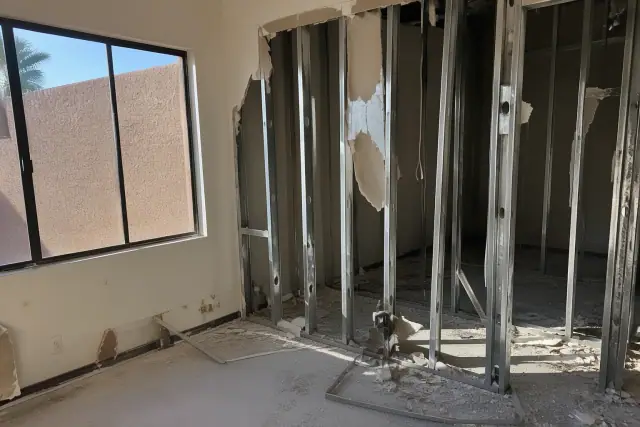 Selective demolition of drywall and metal studs at a room renovation project in Glendale, AZ.