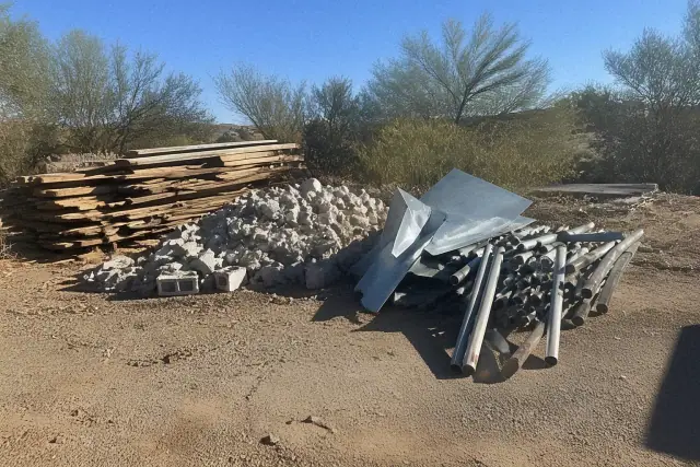 A stack of sorted construction waste including wood, metal, and masonry for site clearing in Glendale, AZ.