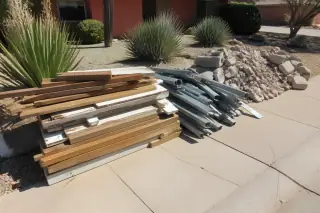 Neat pile of sorted wood, metal, and masonry debris on a cleared jobsite in Phoenix, AZ.