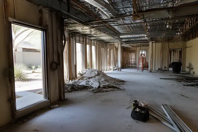 Interior structural demolition in progress with exposed framing and debris at a construction site in Chandler, AZ.