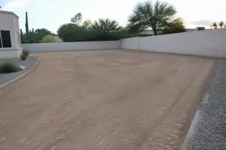 Cleared and leveled residential building footprint with gravel xeriscaping at a property in Phoenix, AZ.