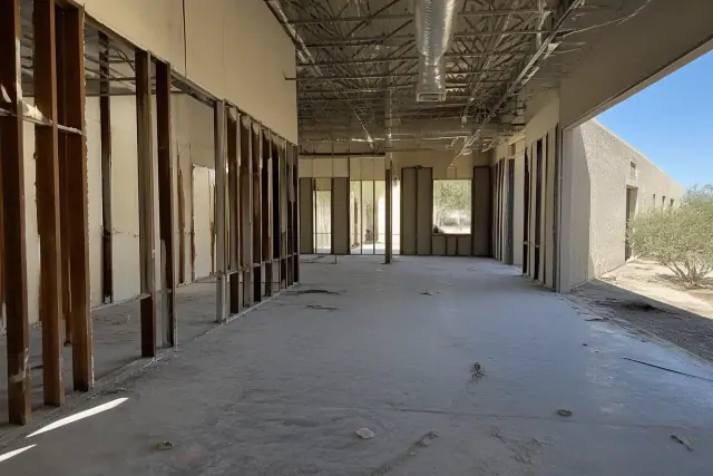 Interior view of a warehouse demolition project with exposed structural studs in Phoenix, AZ.