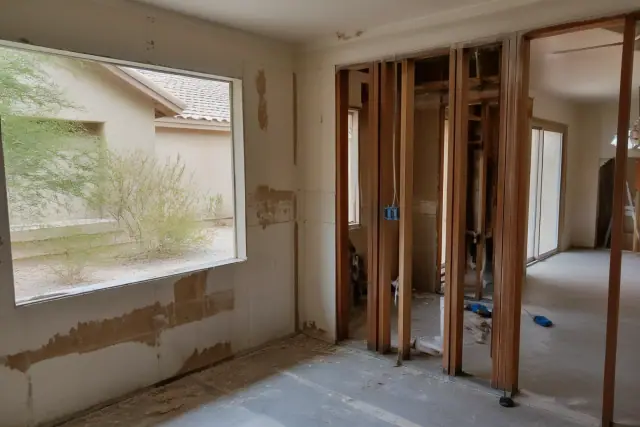 Interior of a home during a residential demolition project with exposed wall framing in Phoenix, AZ.