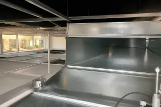 Cleaned metal ventilation trunk interior with foil tape near high windows in a Phoenix, AZ building.