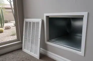 Sanitized interior of a return air duct viewed through a wall vent opening in a Phoenix, AZ home.