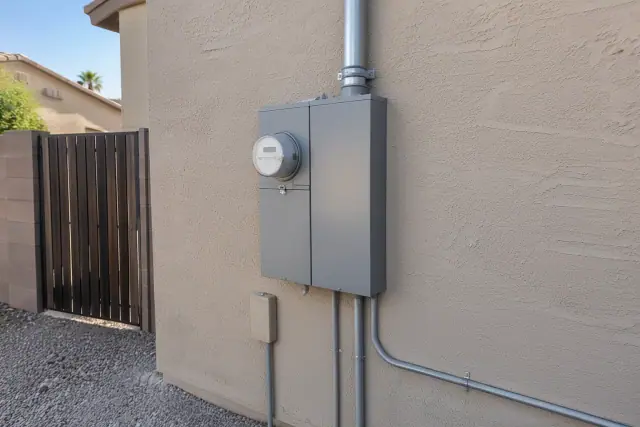 200 amp service upgrade with utility meter and main breaker on a stucco wall in Phoenix, AZ.
