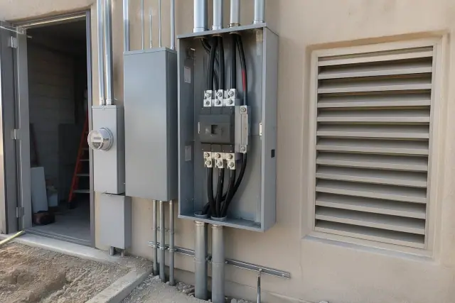 Technician taking a smartphone photo of a 400 Amp commercial service upgrade on a job site in Phoenix, AZ.