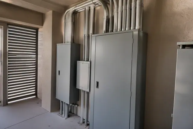 Technician photo of commercial electrical panel upgrades with conduit runs in Phoenix, AZ.