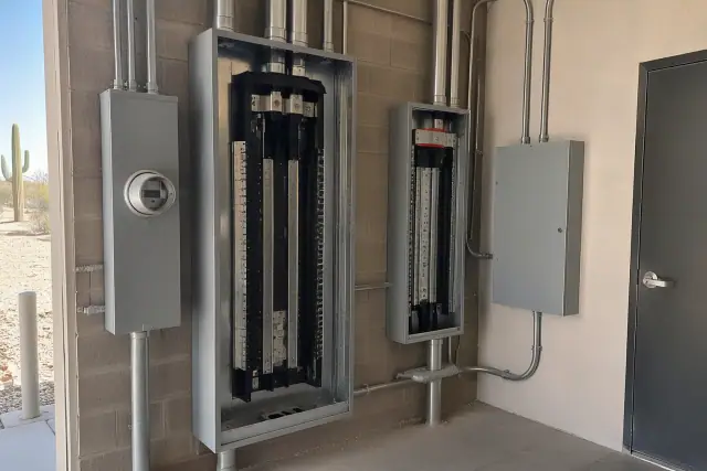 Commercial electrical panel upgrade in Phoenix, AZ, showing heavy-gauge conduit and breaker housing.
