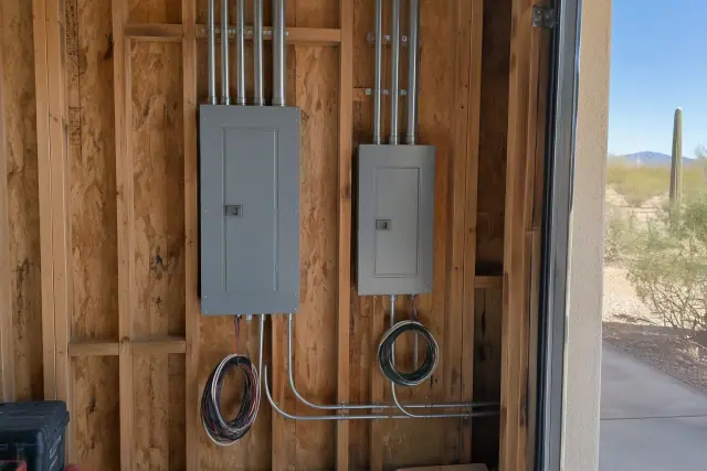 Electrician's progress photo of newly installed subpanels in a Phoenix, AZ detached garage workshop.
