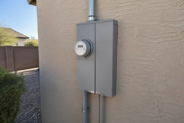 New electrical meter box replacement mounted on a stucco exterior wall in Mesa, AZ.