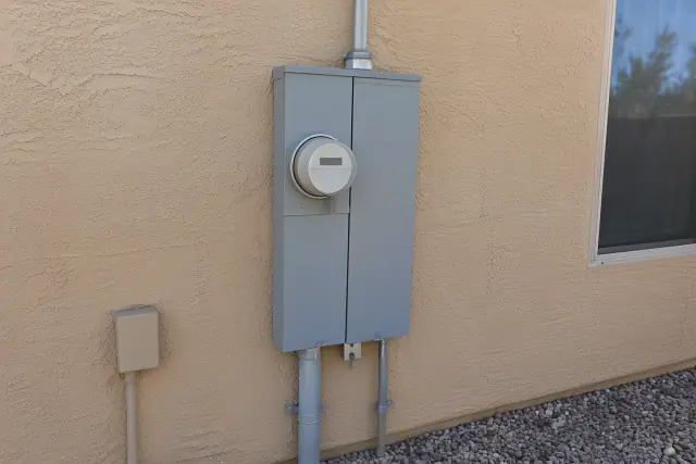 Electrical meter box replacement on a stucco wall with new conduit in Surprise, AZ.