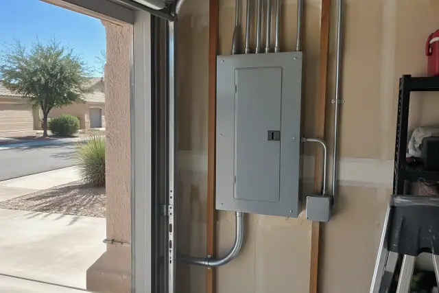 New electrical panel replacement on a residential garage wall in Buckeye, AZ.