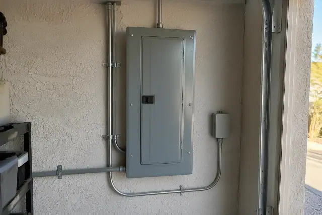 New electrical panel installed after Zinsco removal on a garage stucco wall in Phoenix, AZ.