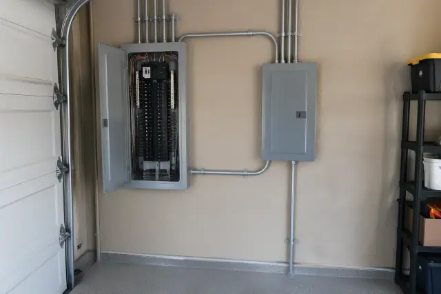 Newly installed electrical subpanel on a garage wall in Glendale, AZ.