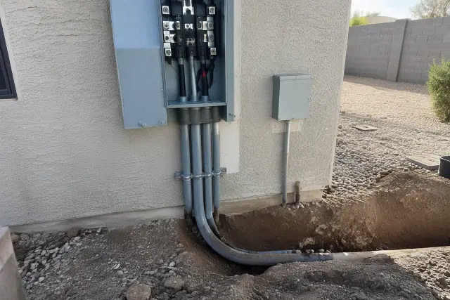 Underground service lateral upgrade and 400 amp service box on a stucco wall in Phoenix, AZ.