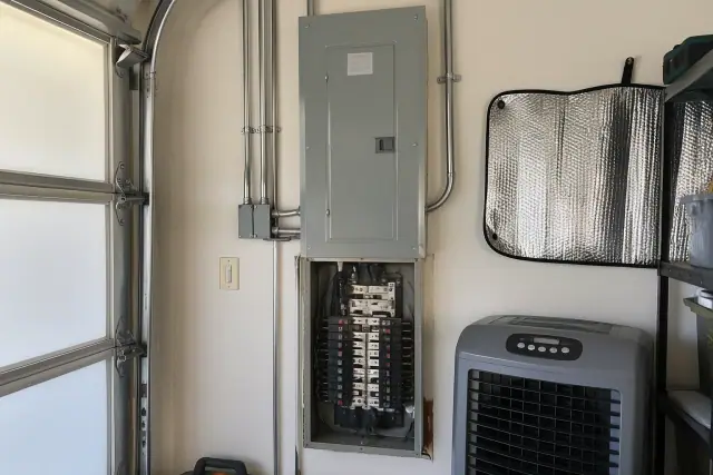 Zinsco electrical panel replacement on a garage wall in Scottsdale, AZ.