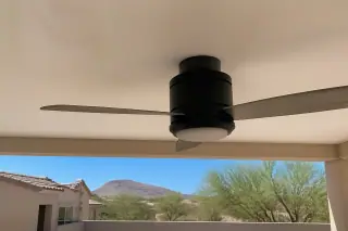 Ceiling fan motor housing mounted on a white ceiling in a stucco home in Phoenix, AZ.