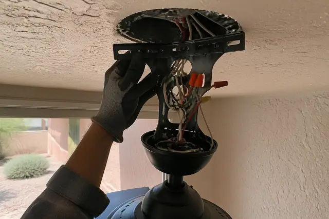 Technician installing a dual-control ceiling fan wiring layout in a home in Phoenix, AZ.