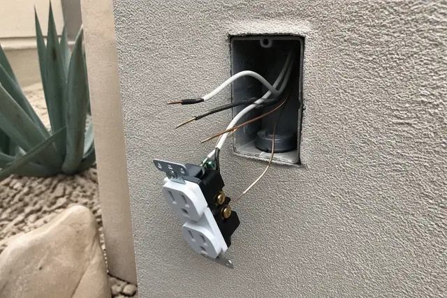 Exposed copper wiring in an electrical wall box during a home repair project in Gilbert, AZ.