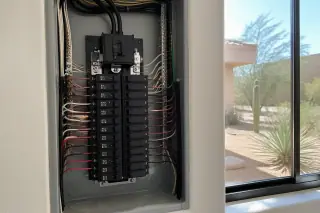 A modern residential electrical breaker panel with new circuit breakers in a Phoenix, AZ home.