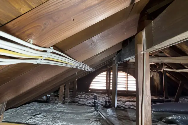 New electrical wiring installed alongside old knob-and-tube wires in a Phoenix, AZ attic.