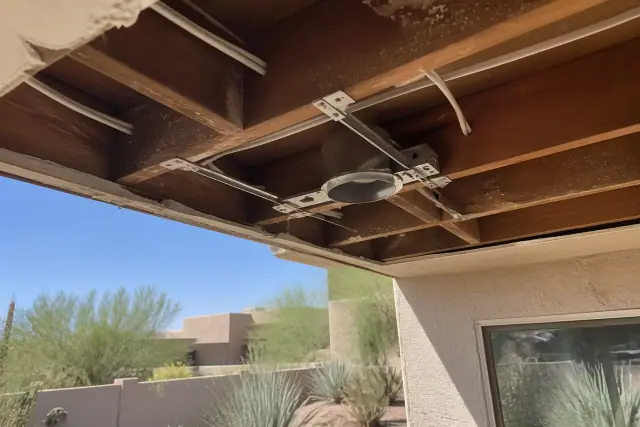 New recessed lighting installation with exposed wiring and housing clips in a Tempe, AZ home renovation.