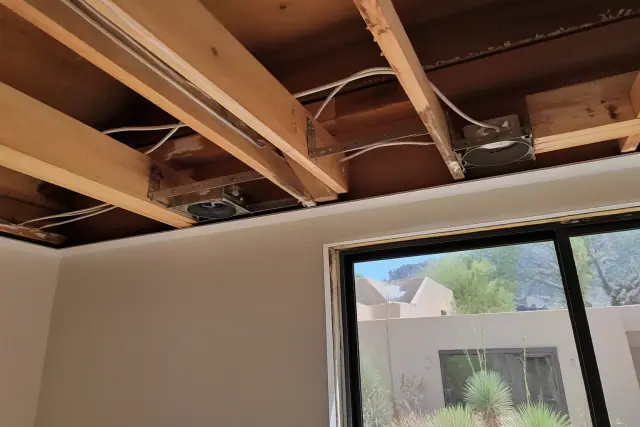 Exposed ceiling joist with insulated wiring and metal housing for recessed lighting in a Paradise Valley, AZ home.