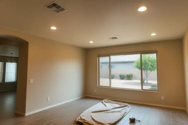 Recessed ceiling lights installed in a Gilbert, AZ home with a drop cloth and tools visible on the floor.