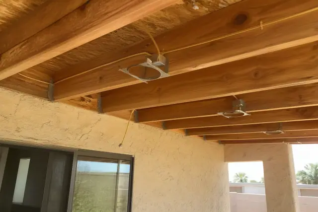 Open ceiling joist with insulated wiring and light housing clips during a recessed lighting project in Phoenix, AZ.