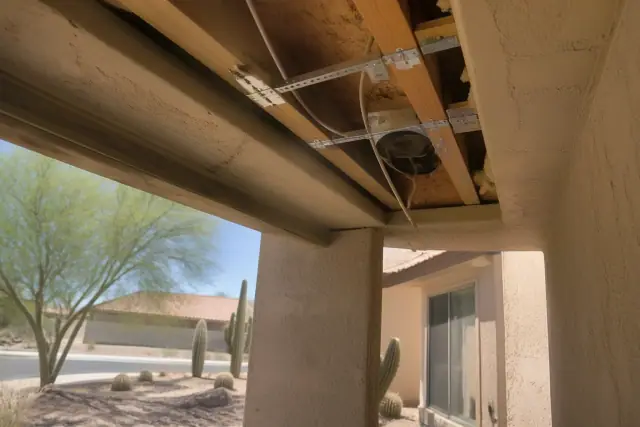 Exposed ceiling joists and wiring prepared for a lighting installation at a residential job site in Phoenix, AZ.