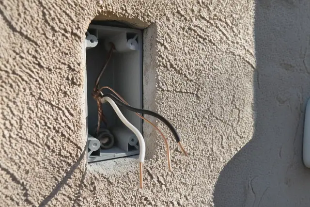 Exposed electrical wall box with copper wiring for an outlet installation at a job site in Phoenix, AZ.