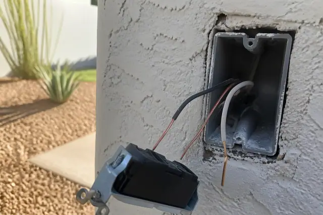 Exposed electrical wall box with copper wiring for a smart switch installation in a home in Phoenix, AZ.
