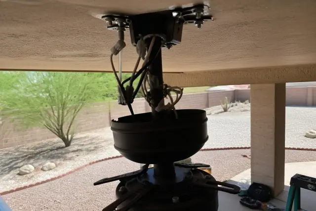 Ceiling fan mounting bracket and electrical wiring installation in a Phoenix, AZ home.