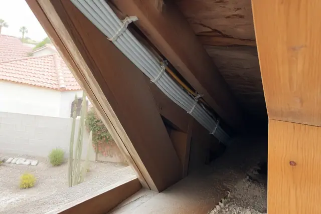 New electrical wiring bundled along wooden attic rafters during a whole home rewire in Phoenix, AZ.