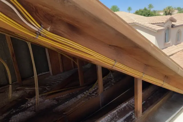 Bundle of electrical cables stapled to rafters during a whole home rewiring project in Tempe, AZ.