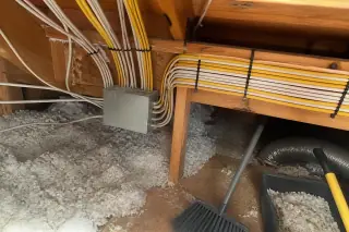 Neatly stapled electrical cables and junction boxes installed during a home rewiring project in Phoenix, AZ.