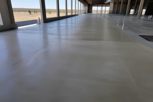 6-8 mil base coat on prepared concrete flooring inside a logistics building in Phoenix, AZ.