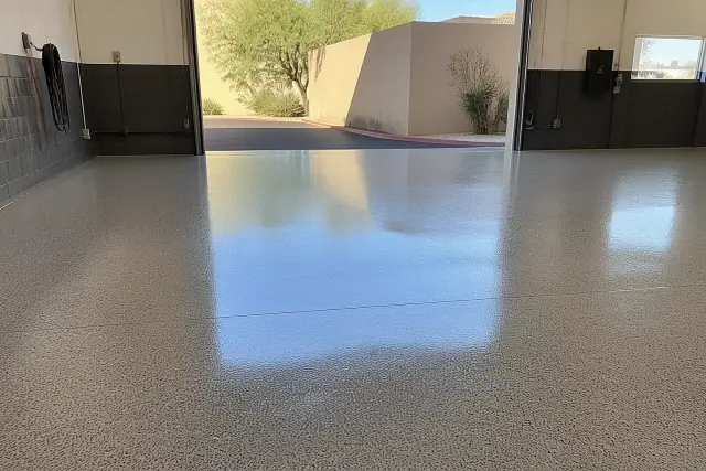 Completed commercial epoxy flooring with a glossy finish in a Scottsdale, AZ workshop with desert landscaping outside.