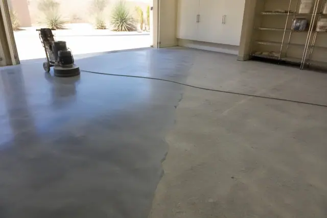 Half-polished concrete floor with grinding patterns in a residential garage in Paradise Valley, AZ.