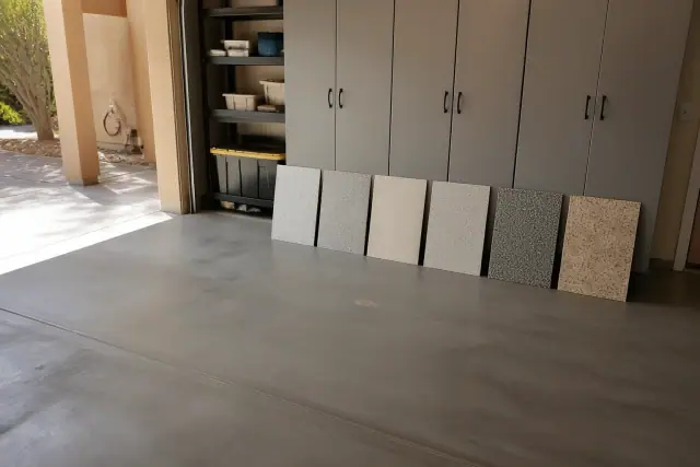 Cured coating sample boards leaning against cabinets in a garage in Phoenix, AZ.