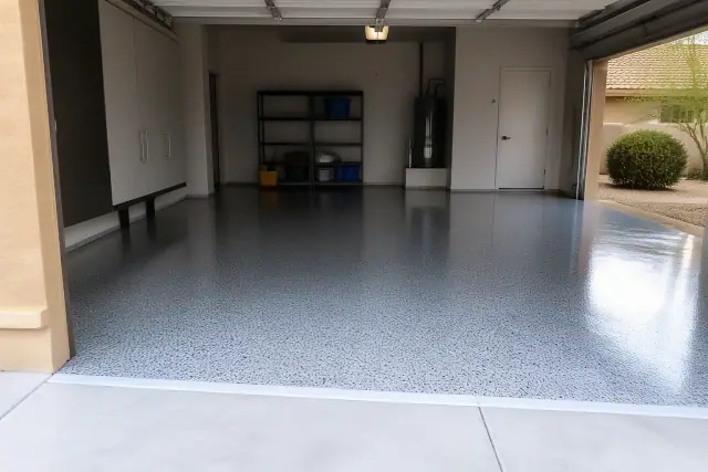A high-gloss decorative flake garage floor coating in a Phoenix, AZ residence with storage cabinets and desert views.