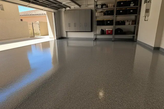 Glossy epoxy and polyaspartic garage floor coating with storage cabinets in a residential home in Phoenix, AZ.