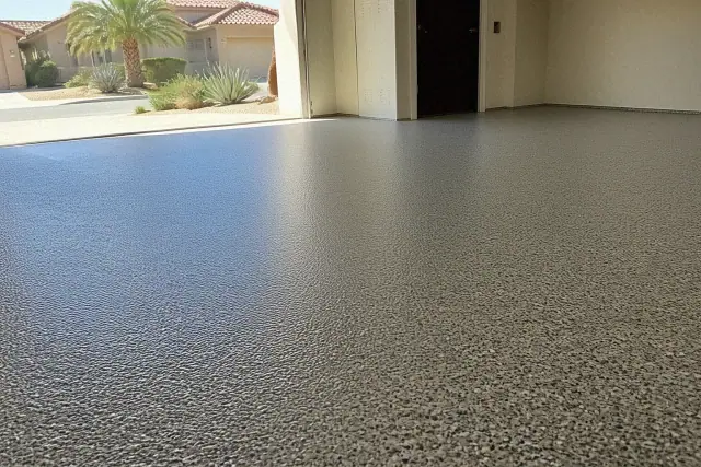 Epoxy flake flooring inside a residential garage in Chandler, AZ with a view of suburban houses through the open door.